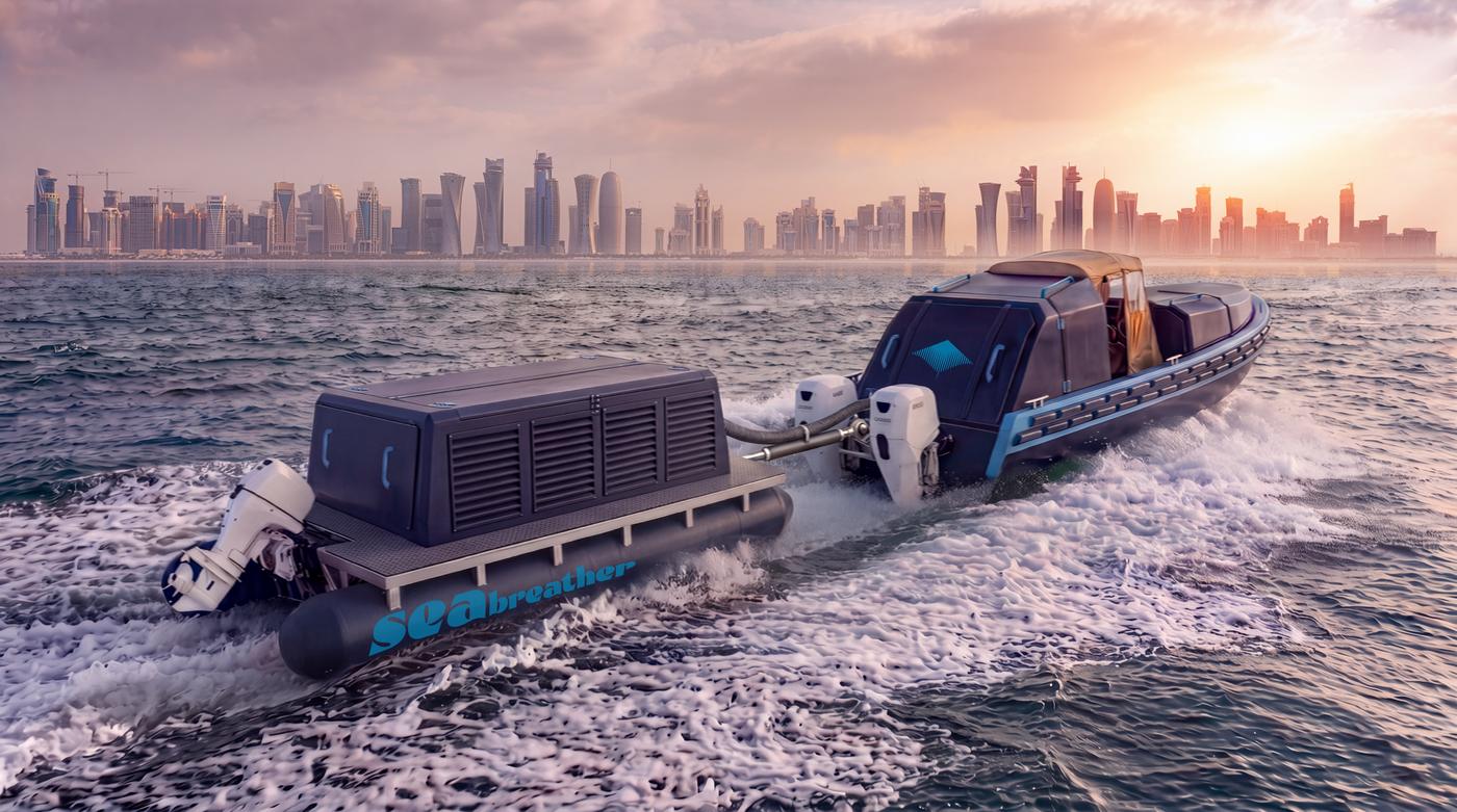 A Super SeaBreather with a gas barge alongside, running past a Gulf city skyline at sunset